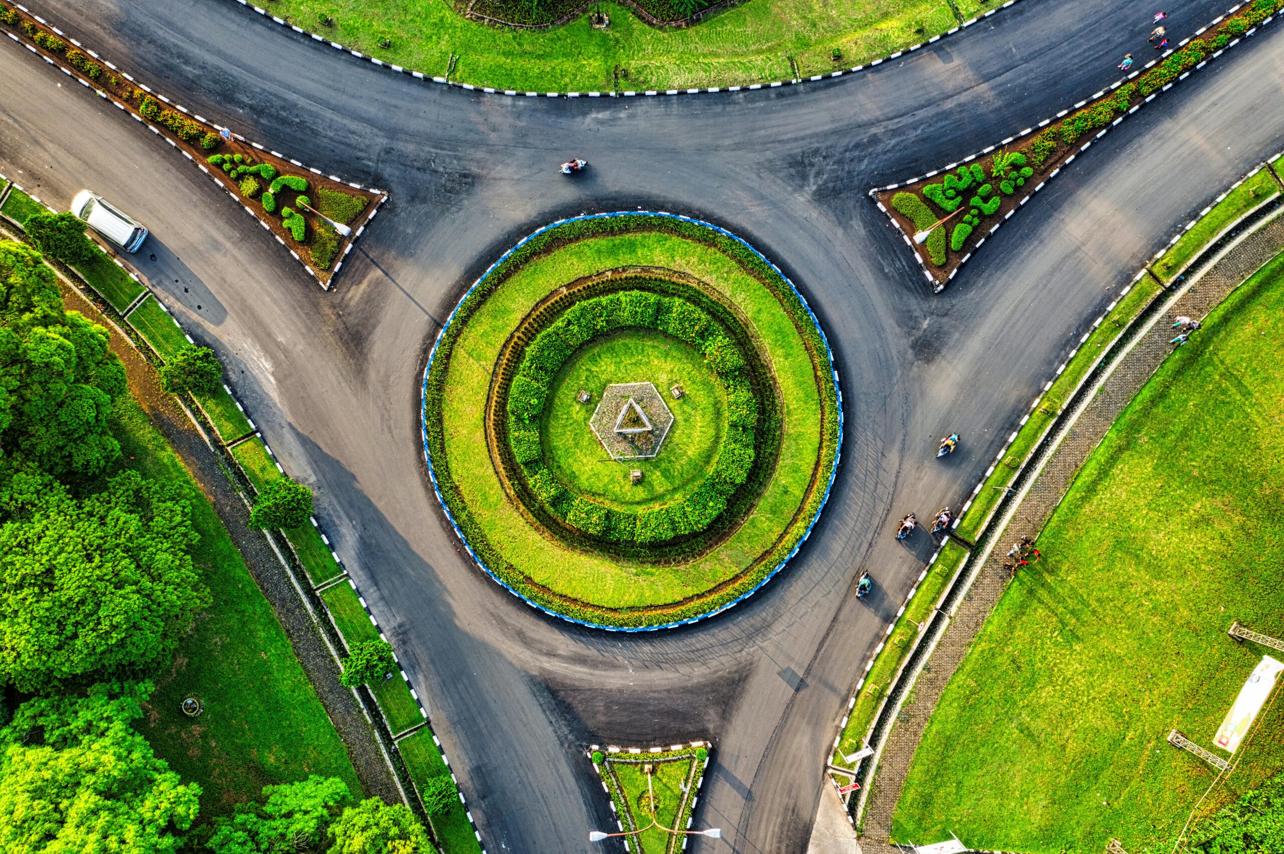 Vibrant aerial photo of a green roundabout in Jawa Barat, Indonesia, highlighting urban landscaping.